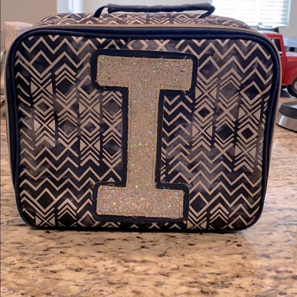 Justice lunch box with “I”